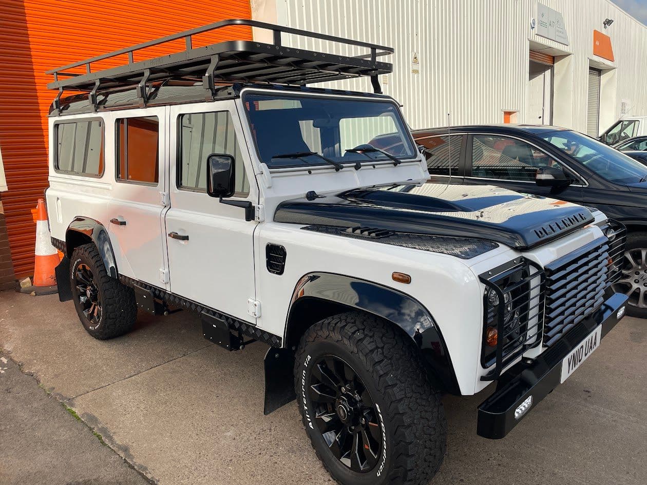 Left hand drive Land Rover Defender Puma EV conversion with 100 kWh Tesla battery pack and active cooling system